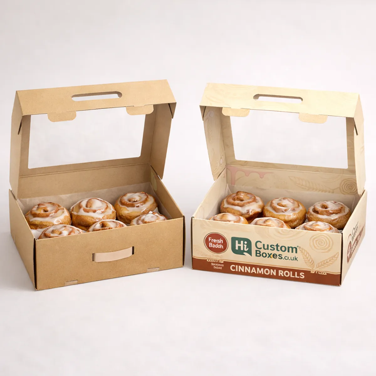 Two gabled gift boxes with integrated handles, one plain brown kraft and one with decorative cinnamon-themed branding. class=